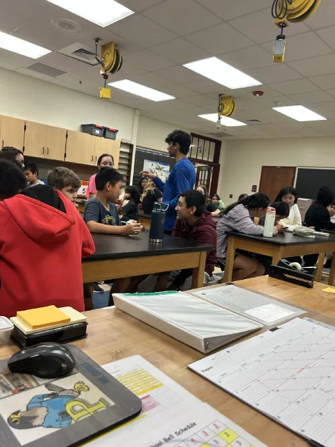 Students developing payload ideas around a classroom table